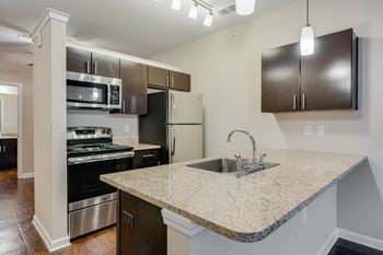 Kitchen With Granite Countertops, Espresso Cabinetry & Stainless Steel Appliances